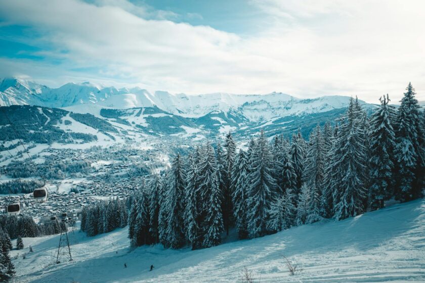 A snowy mountain with trees and snow covered slopes