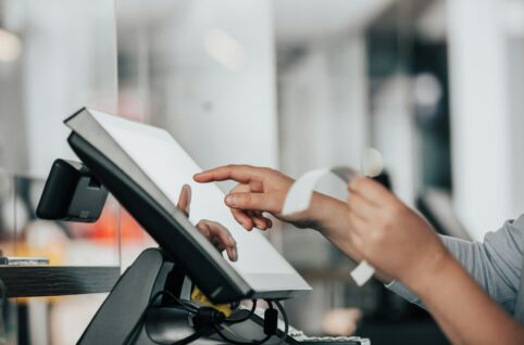 a person is using a pos machine in a store